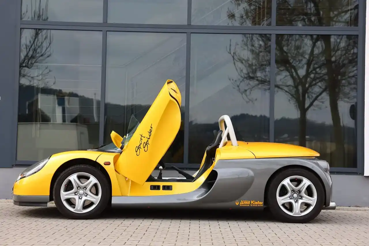 Gelber Renault Sport Spider mit geöffneten Scherentüren